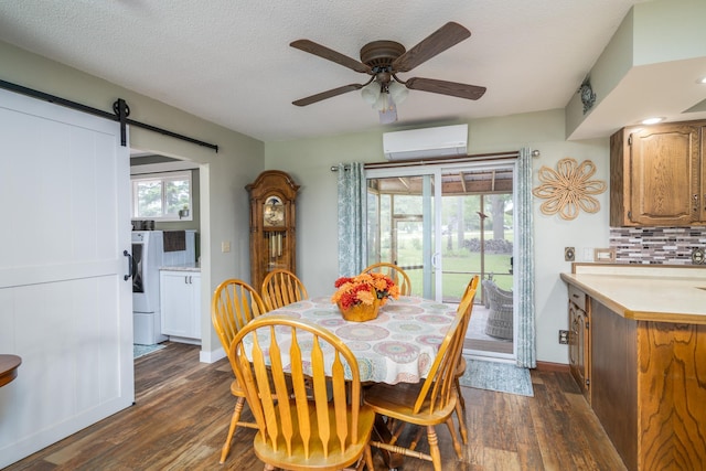701 Mill St, Fertile, MN 56540 - dining space featuring a wall mounted air conditioner, dark wood-type flooring, a barn door, and a ceiling fan