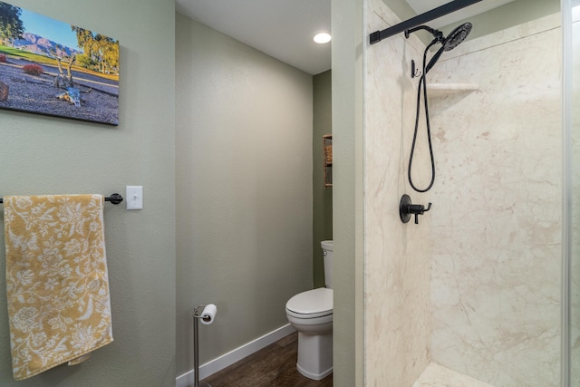 701 Mill St, Fertile, MN 56540 - bathroom with wood finished floors, toilet, a shower stall, and baseboards