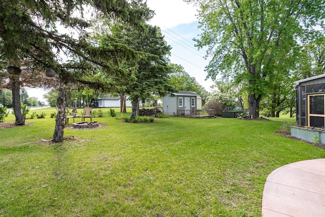 701 Mill St, Fertile, MN 56540 - view of grassy yard featuring an outdoor fire pit and a deck
