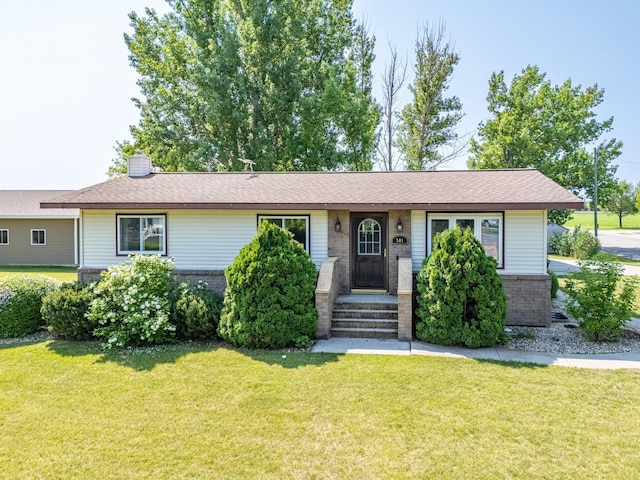 501 Thompson Ave, Fisher, MN 56723 - ranch-style home featuring a front yard, brick siding, and roof with shingles