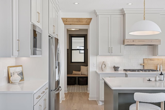 10154 Peony Ln N, Maple Grove, MN 55311 - kitchen with appliances with stainless steel finishes, light wood-style floors, light countertops, decorative backsplash, and recessed lighting