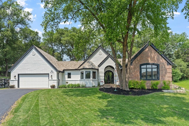 6141 Sherman Cir, Edina, MN 55436 - view of front of property with asphalt driveway, an attached garage, a front yard, and brick siding