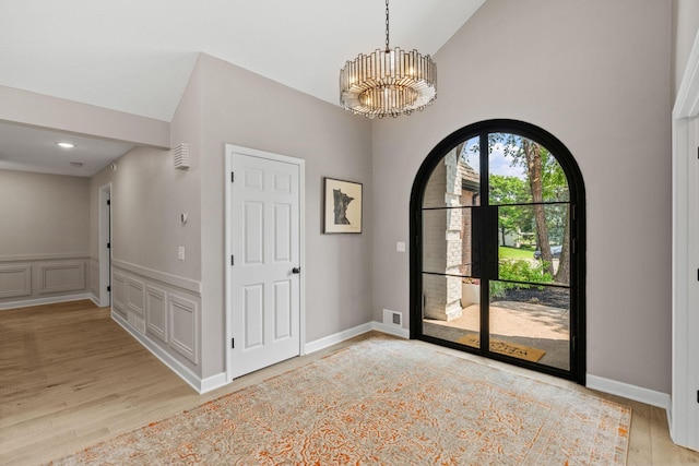 6141 Sherman Cir, Edina, MN 55436 - foyer with a chandelier, light wood finished floors, and high vaulted ceiling