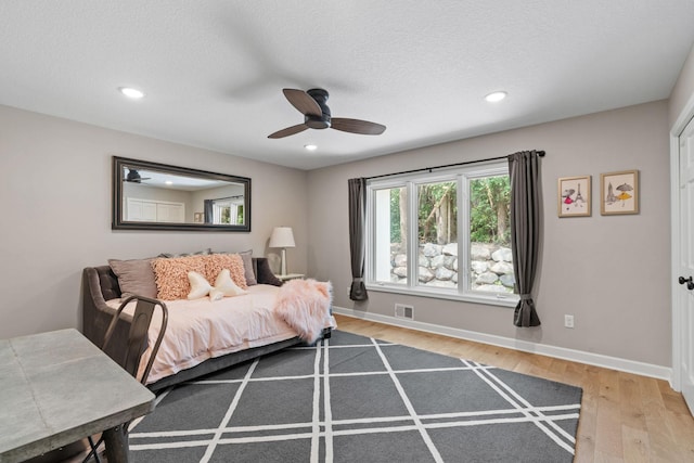 6141 Sherman Cir, Edina, MN 55436 - bedroom with light wood-type flooring, recessed lighting, a textured ceiling, and a ceiling fan