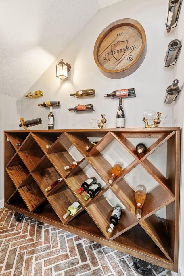 6141 Sherman Cir, Edina, MN 55436 - wine room featuring brick flooring and lofted ceiling
