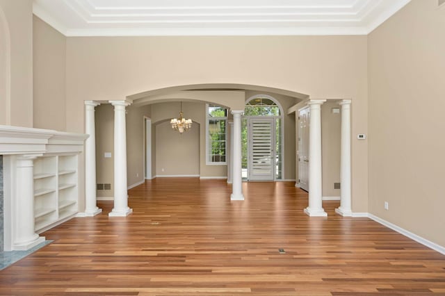 1540 Waterford Ct, Golden Valley, MN 55422 - unfurnished living room with light wood-type flooring, arched walkways, crown molding, a chandelier, and baseboards