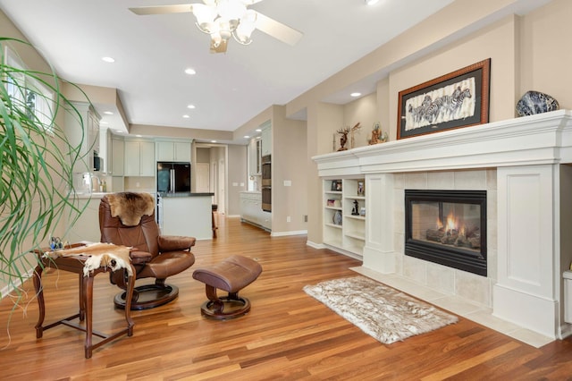 1540 Waterford Ct, Golden Valley, MN 55422 - living room featuring light wood-style floors, ceiling fan, baseboards, a tile fireplace, and recessed lighting