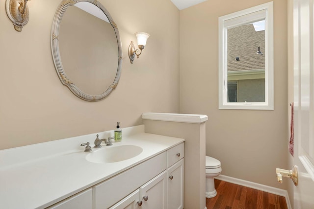 1540 Waterford Ct, Golden Valley, MN 55422 - bathroom with toilet, vanity, wood finished floors, and baseboards