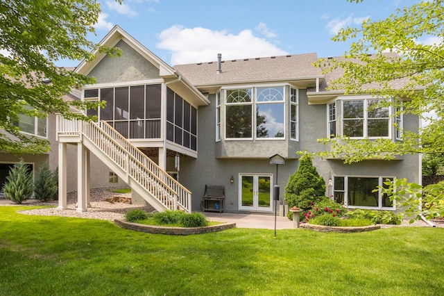 1540 Waterford Ct, Golden Valley, MN 55422 - rear view of house featuring a sunroom, stucco siding, a yard, a patio area, and stairway