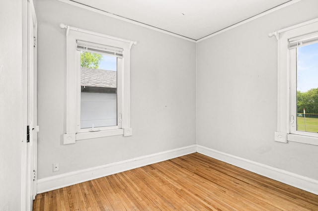 804 20th Ave E, Duluth, MN 55812 - unfurnished room featuring baseboards, healthy amount of natural light, light wood-style floors, and crown molding