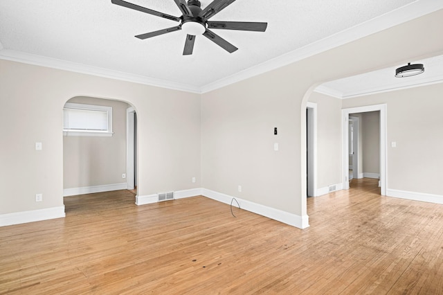 804 20th Ave E, Duluth, MN 55812 - empty room with arched walkways, ornamental molding, light wood-style floors, a ceiling fan, and baseboards