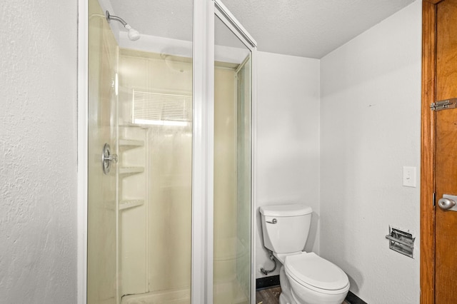 804 20th Ave E, Duluth, MN 55812 - bathroom with a stall shower, a textured ceiling, toilet, and baseboards