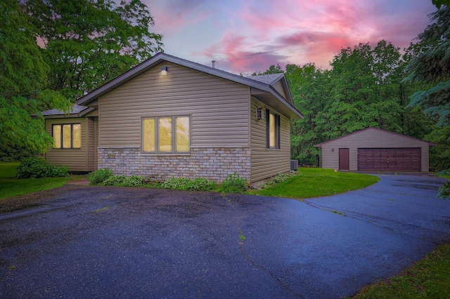 5959 373rd St, North Branch, MN 55056 - property exterior at dusk featuring an outdoor structure, a garage, and a lawn