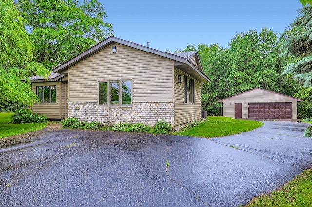 5959 373rd St, North Branch, MN 55056 - view of home's exterior featuring an outbuilding, a garage, and a lawn