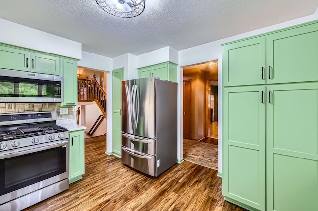 5959 373rd St, North Branch, MN 55056 - kitchen featuring stainless steel appliances, green cabinetry, dark wood finished floors, light countertops, and a textured ceiling