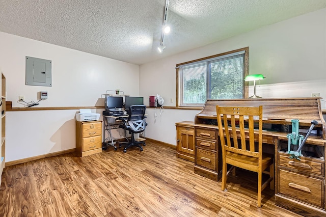 5959 373rd St, North Branch, MN 55056 - home office with electric panel, a textured ceiling, wood finished floors, and rail lighting