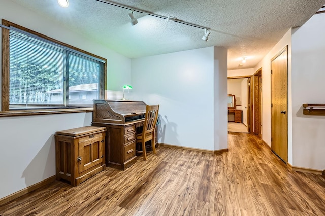 5959 373rd St, North Branch, MN 55056 - office area featuring wood finished floors, rail lighting, and a textured ceiling