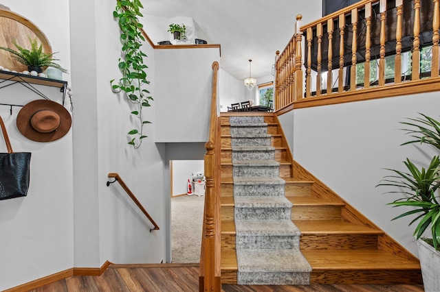 13610 Prairie Ct, Becker, MN 55308 - staircase featuring wood finished floors and a chandelier