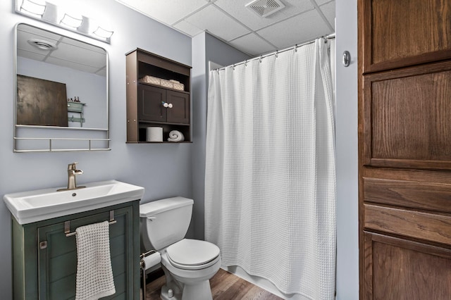 13610 Prairie Ct, Becker, MN 55308 - full bathroom featuring a paneled ceiling, vanity, wood finished floors, and a shower with curtain