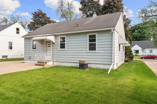 1306 6th Ave NW, Austin, MN 55912 - view of front facade with a shingled roof, a front lawn, and a chimney