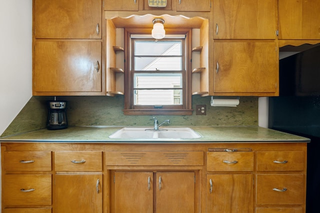 1306 6th Ave NW, Austin, MN 55912 - kitchen with light countertops, brown cabinets, and black refrigerator