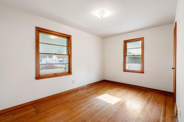 1306 6th Ave NW, Austin, MN 55912 - spare room with hardwood / wood-style floors and baseboards