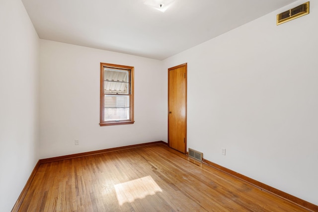 1306 6th Ave NW, Austin, MN 55912 - spare room featuring light wood-type flooring and baseboards