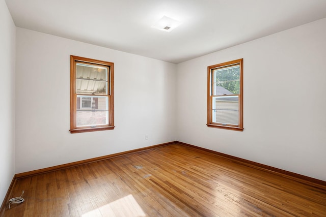 1306 6th Ave NW, Austin, MN 55912 - spare room featuring light wood-type flooring and baseboards