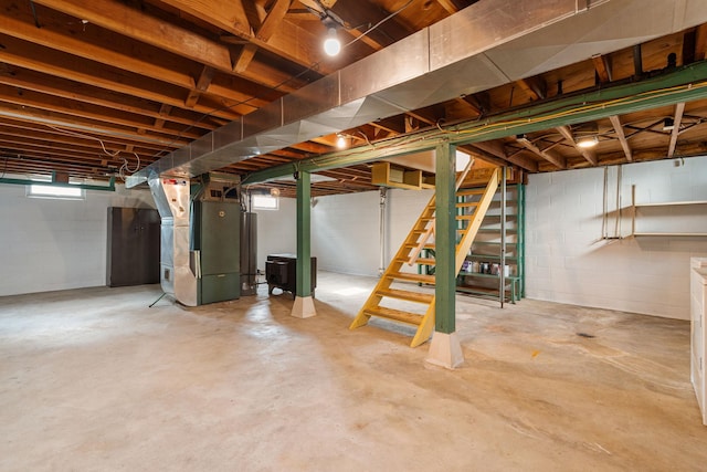 1306 6th Ave NW, Austin, MN 55912 - below grade area featuring stairs and heating unit