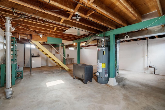 1306 6th Ave NW, Austin, MN 55912 - basement with gas water heater, stairs, washer / dryer, and concrete block wall
