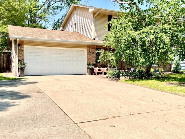 9300 23rd St, Saint Louis Park, MN 55426 - view of front of house featuring concrete driveway, a garage, and brick siding