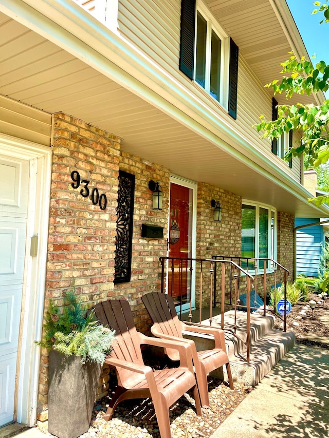 9300 23rd St, Saint Louis Park, MN 55426 - doorway to property with covered porch and brick siding