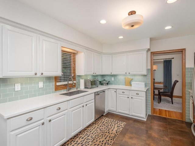 9300 23rd St, Saint Louis Park, MN 55426 - kitchen featuring dishwasher, a sink, white cabinets, light countertops, and tasteful backsplash