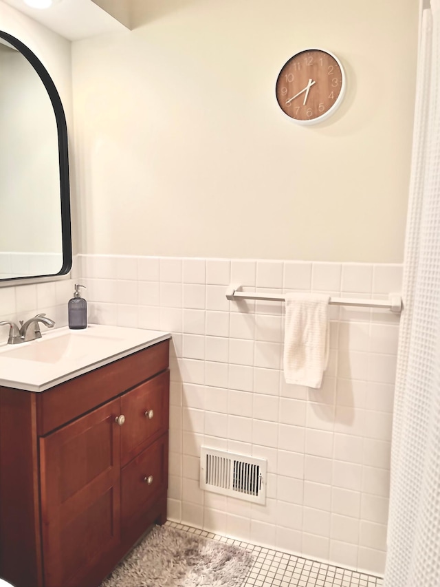 9300 23rd St, Saint Louis Park, MN 55426 - full bathroom with vanity, wainscoting, tile walls, tile patterned flooring, and curtained shower