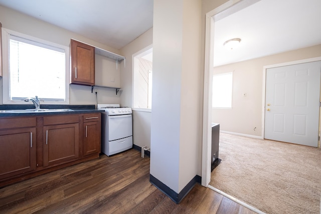 8247 Wentworth Ave S, Bloomington, MN 55420 - kitchen featuring white gas range, a sink, baseboards, and dark wood-type flooring