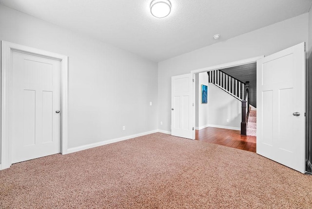 10388 188th St W, Lakeville, MN 55044 - carpeted empty room featuring stairs and baseboards