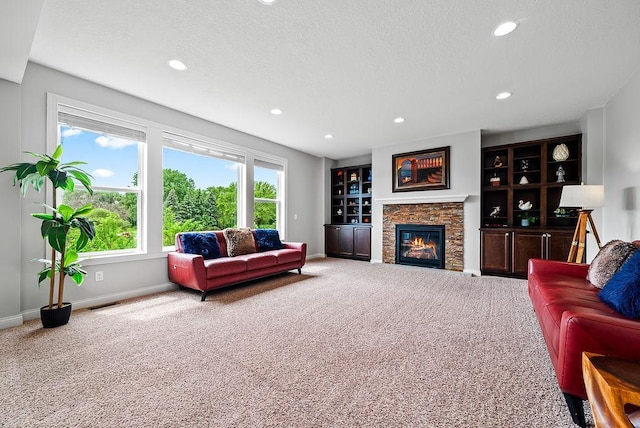 10388 188th St W, Lakeville, MN 55044 - living room featuring carpet floors, a fireplace, recessed lighting, baseboards, and a textured ceiling