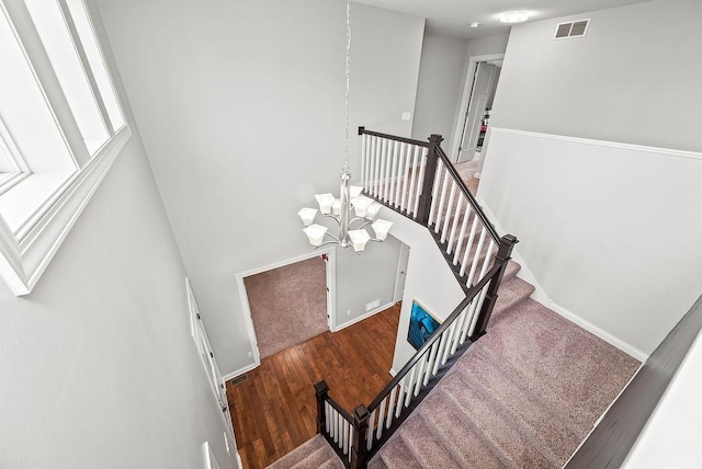 10388 188th St W, Lakeville, MN 55044 - staircase with a chandelier, wood finished floors, and baseboards