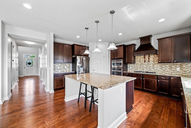 10388 188th St W, Lakeville, MN 55044 - kitchen with premium range hood, dark wood-style floors, a center island, appliances with stainless steel finishes, and backsplash