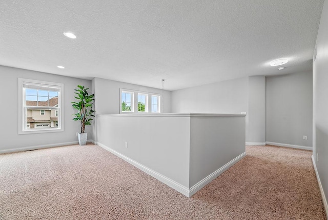10388 188th St W, Lakeville, MN 55044 - carpeted empty room featuring a textured ceiling, plenty of natural light, baseboards, and recessed lighting