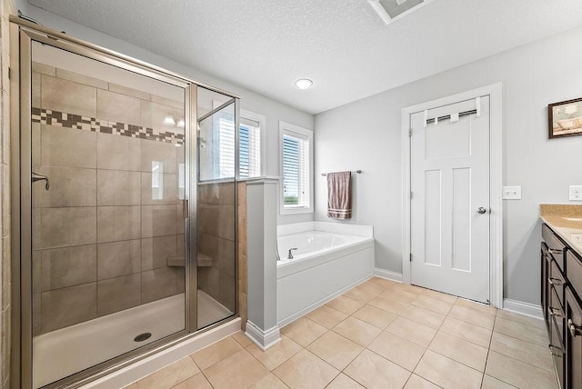 10388 188th St W, Lakeville, MN 55044 - bathroom with a garden tub, a stall shower, vanity, tile patterned flooring, and a textured ceiling