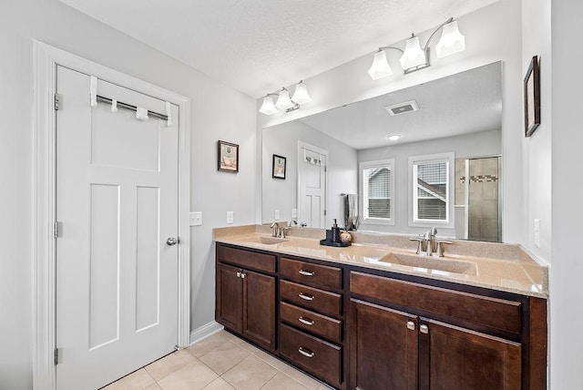 10388 188th St W, Lakeville, MN 55044 - full bath with tile patterned floors, a tile shower, double vanity, and a textured ceiling