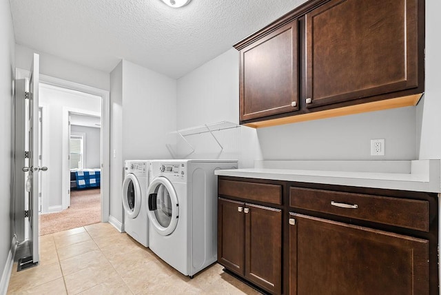 10388 188th St W, Lakeville, MN 55044 - laundry room featuring cabinet space, washer and dryer, a textured ceiling, light colored carpet, and light tile patterned floors
