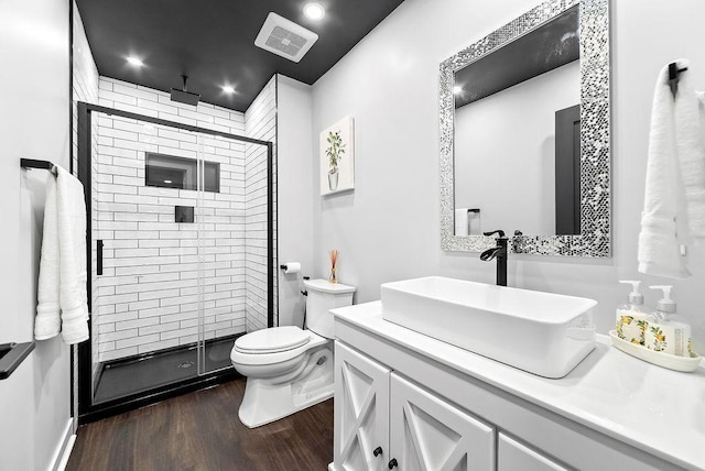 10388 188th St W, Lakeville, MN 55044 - bathroom featuring vanity, wood finished floors, a stall shower, toilet, and recessed lighting