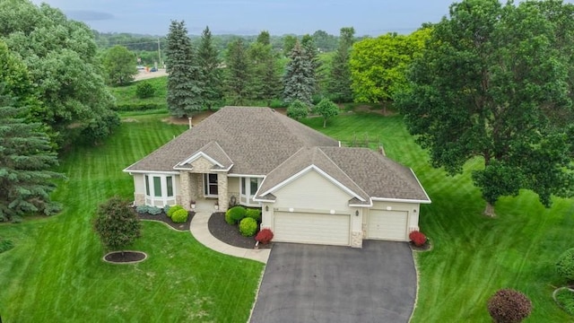 3114 Canyon Cir, Chaska, MN 55318 - view of front of house featuring an attached garage, asphalt driveway, and a front lawn