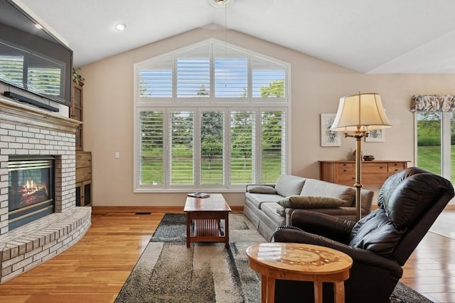3114 Canyon Cir, Chaska, MN 55318 - living room featuring light wood-style flooring, vaulted ceiling, and a fireplace