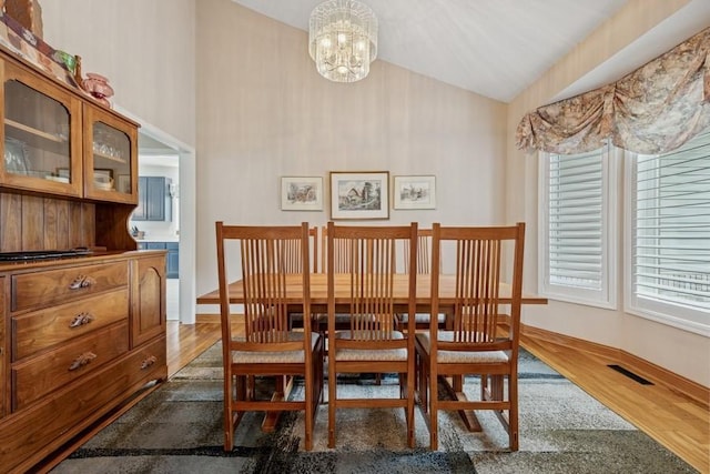 3114 Canyon Cir, Chaska, MN 55318 - dining space featuring a chandelier, wood finished floors, and high vaulted ceiling