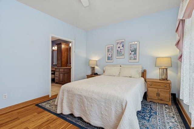 3114 Canyon Cir, Chaska, MN 55318 - bedroom featuring wood finished floors, connected bathroom, and ceiling fan