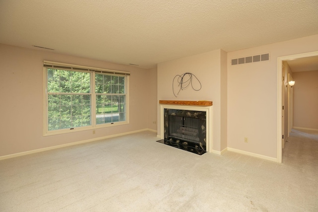 2051 Carriage Dr SW Unit 2051E, Rochester, MN 55902 - unfurnished living room with a premium fireplace, carpet flooring, and a textured ceiling