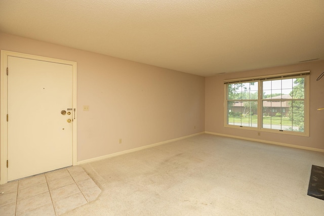 2051 Carriage Dr SW Unit 2051E, Rochester, MN 55902 - spare room with light carpet and light tile patterned floors